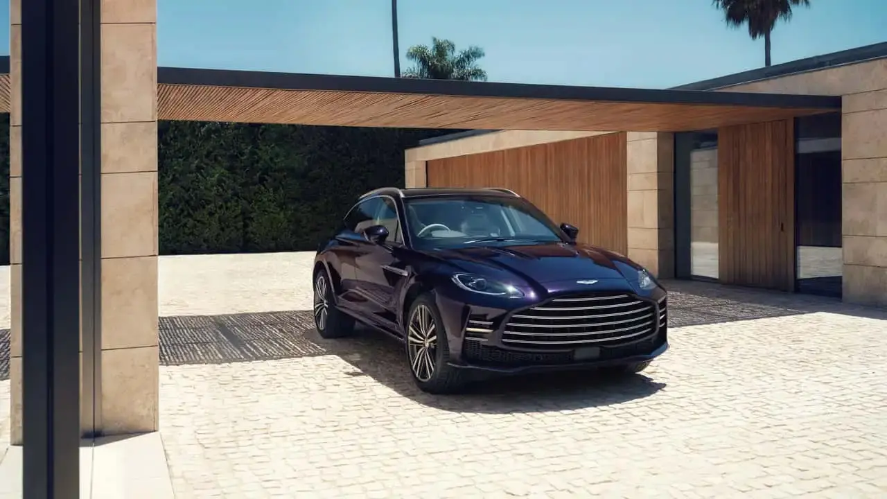 شاسی‌بلند استون مارتین (Aston Martin) DBX با بدنه بنفش در محوطه ویلا